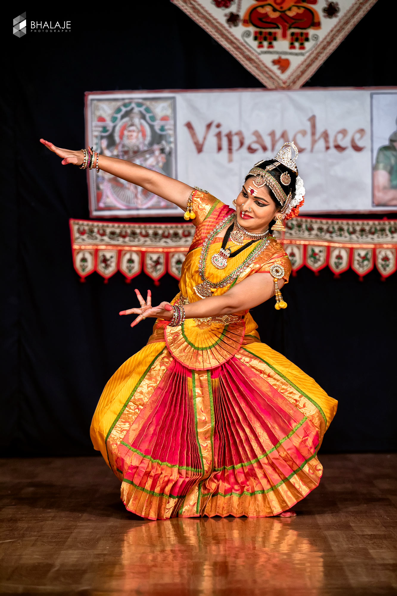 Bharatanatyam dancer mid-performance, photographed live